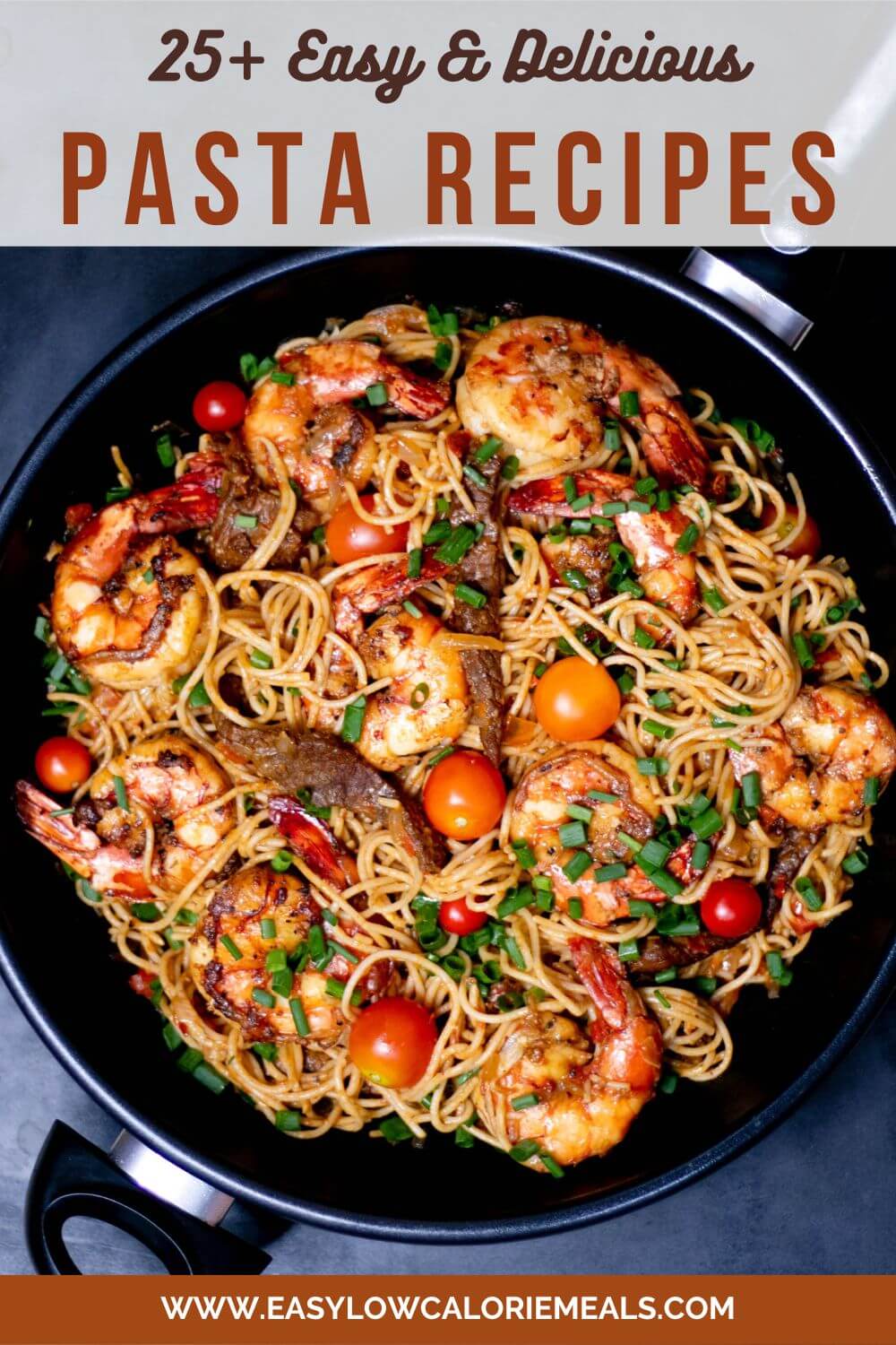 spaghetti pasta with shrimp in a black pan, garnished with spring onions.