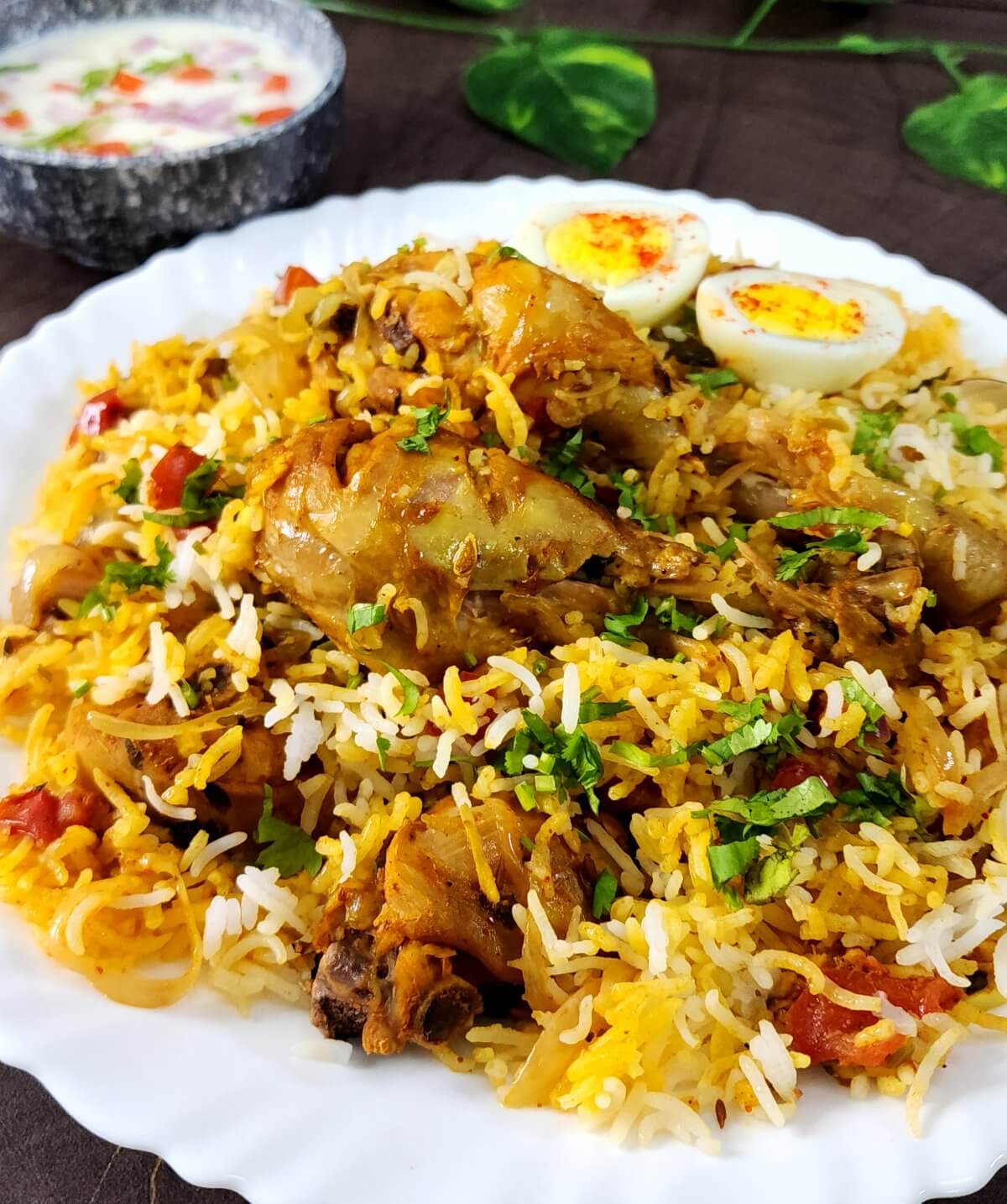 Close up shot of easy to make chicken biryani served in a white plate.